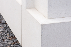  Die farblich einheitliche Fassade wurde aus weißem, offenporigem Beton realisiert  