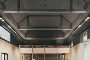  Das Foyer – eine ehemalige Turnhalle – vermittelt zwischen Eingang und Westhof (rechts). Im Rücken die Treppe zu Garderoben und WC im UG sowie alte Garderobenschränke aus dem Altbau, hier nur optisch und technisch frisch gemacht 