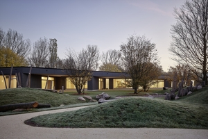  Die Spiellandschaft, in diesem Falle bei winterlicher Morgensonne fotografiert, fungiert von außen auch als visueller Puffer für die ansonsten mit großzügigem Blick nach draußen angelegten Gruppenräume 