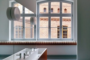  Die neuen Sanitär-, Garderoben- und Kücheneinbauten sind von Wänden und Decken abgerückt, so dass die ehemaligen Klassenräume in ihrer Dimension erfahrbar bleiben 
